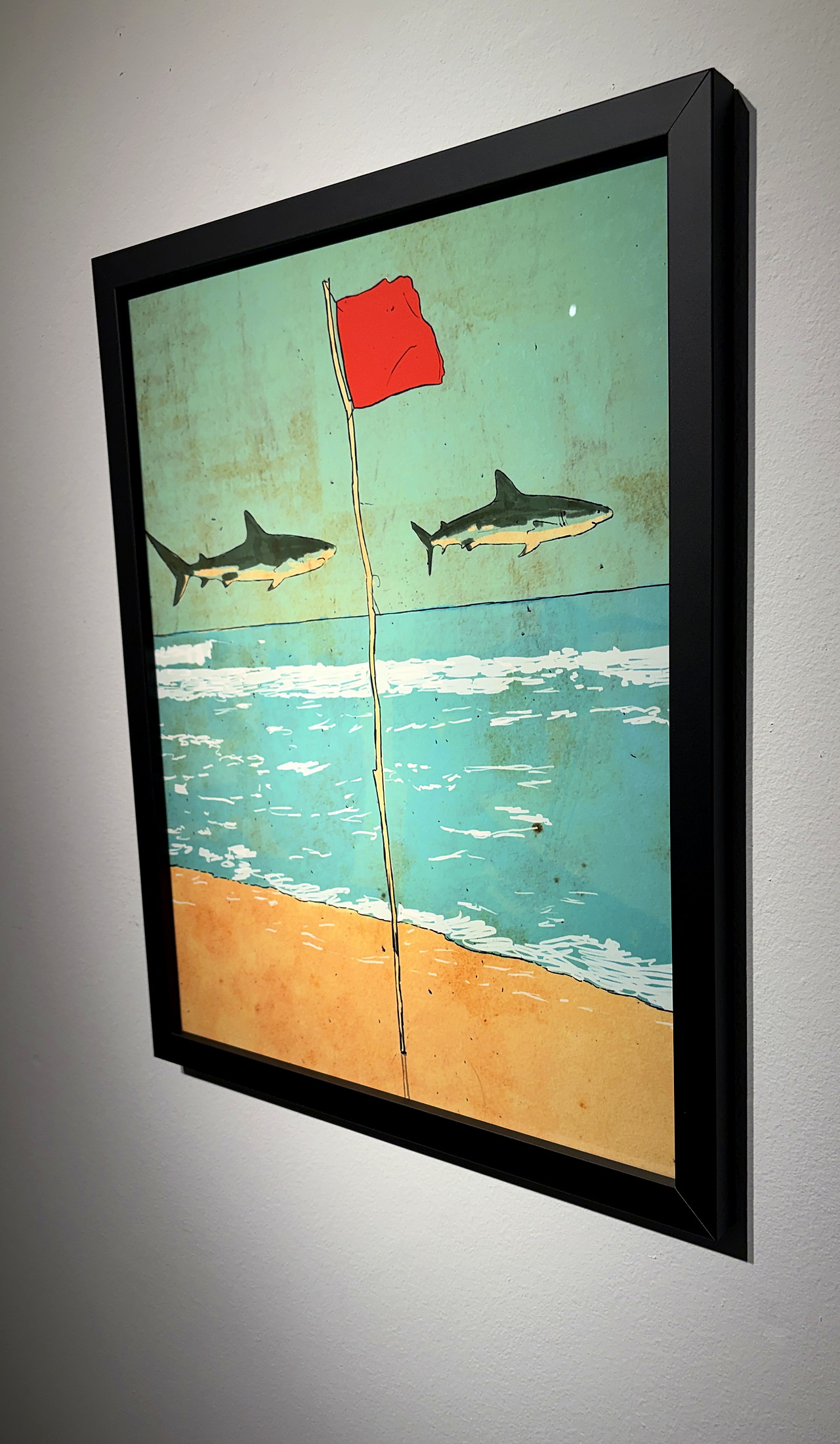 The matte black frame from the side, on a white gallery wall.