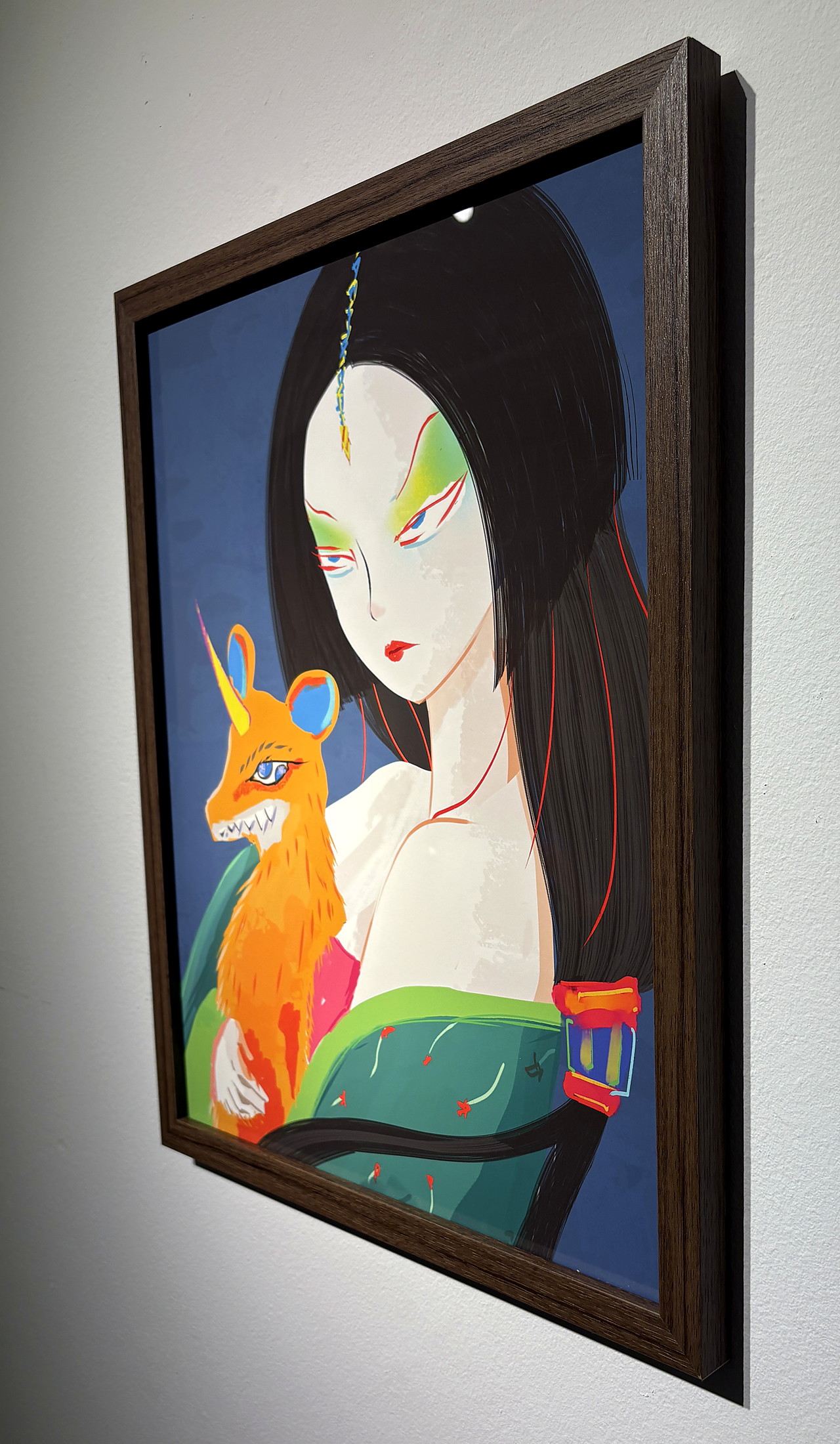 The dark wood frame from the side, on a white gallery wall.